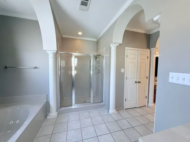 a bathroom with a bathtub and a shower