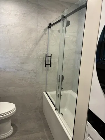 a bathroom with a shower and a toilet