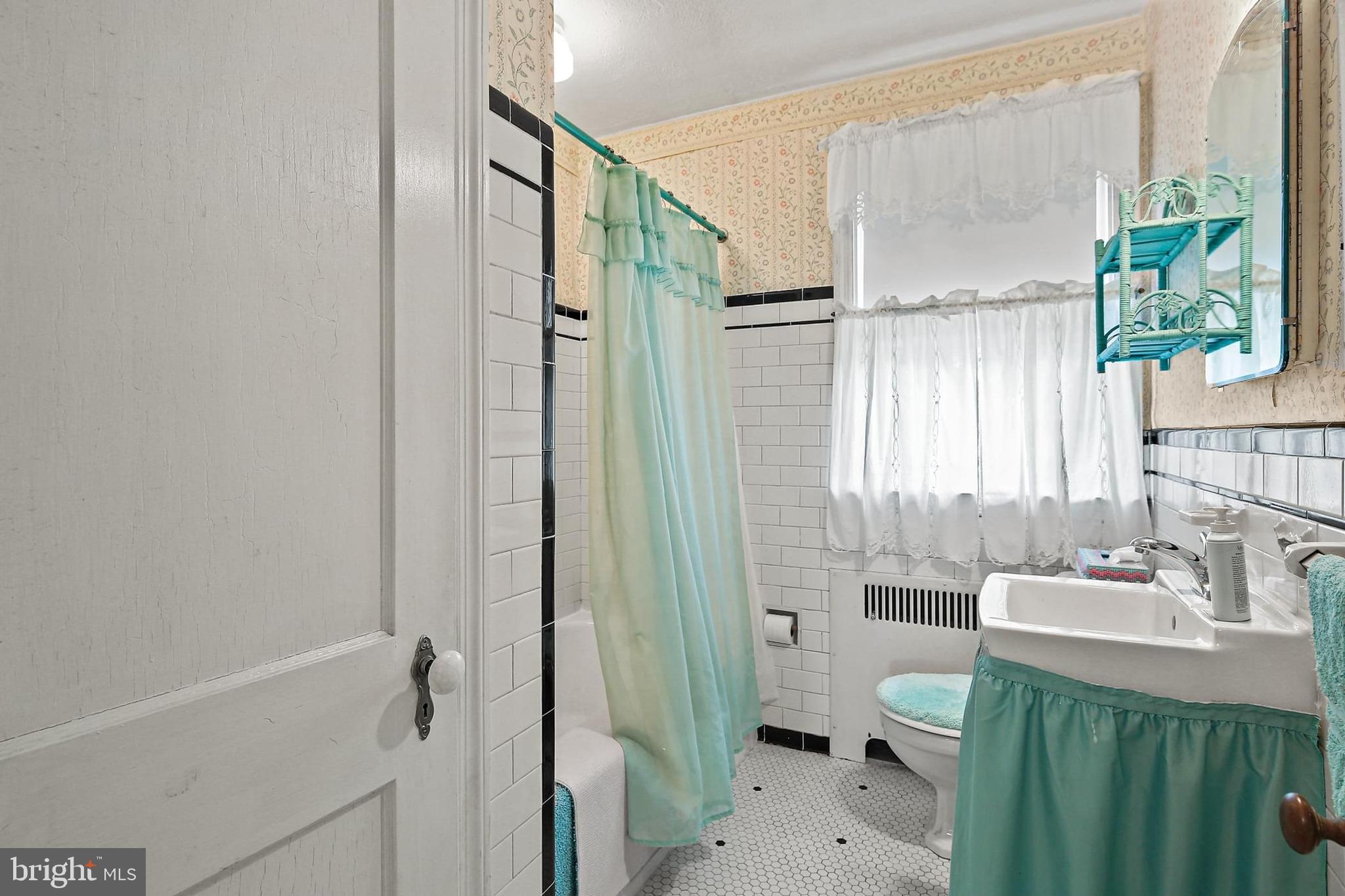 48 Dunkirk Road Baltimore, MD 21212 - Photo 20 of 34 a bathroom with a sink a toilet and shower