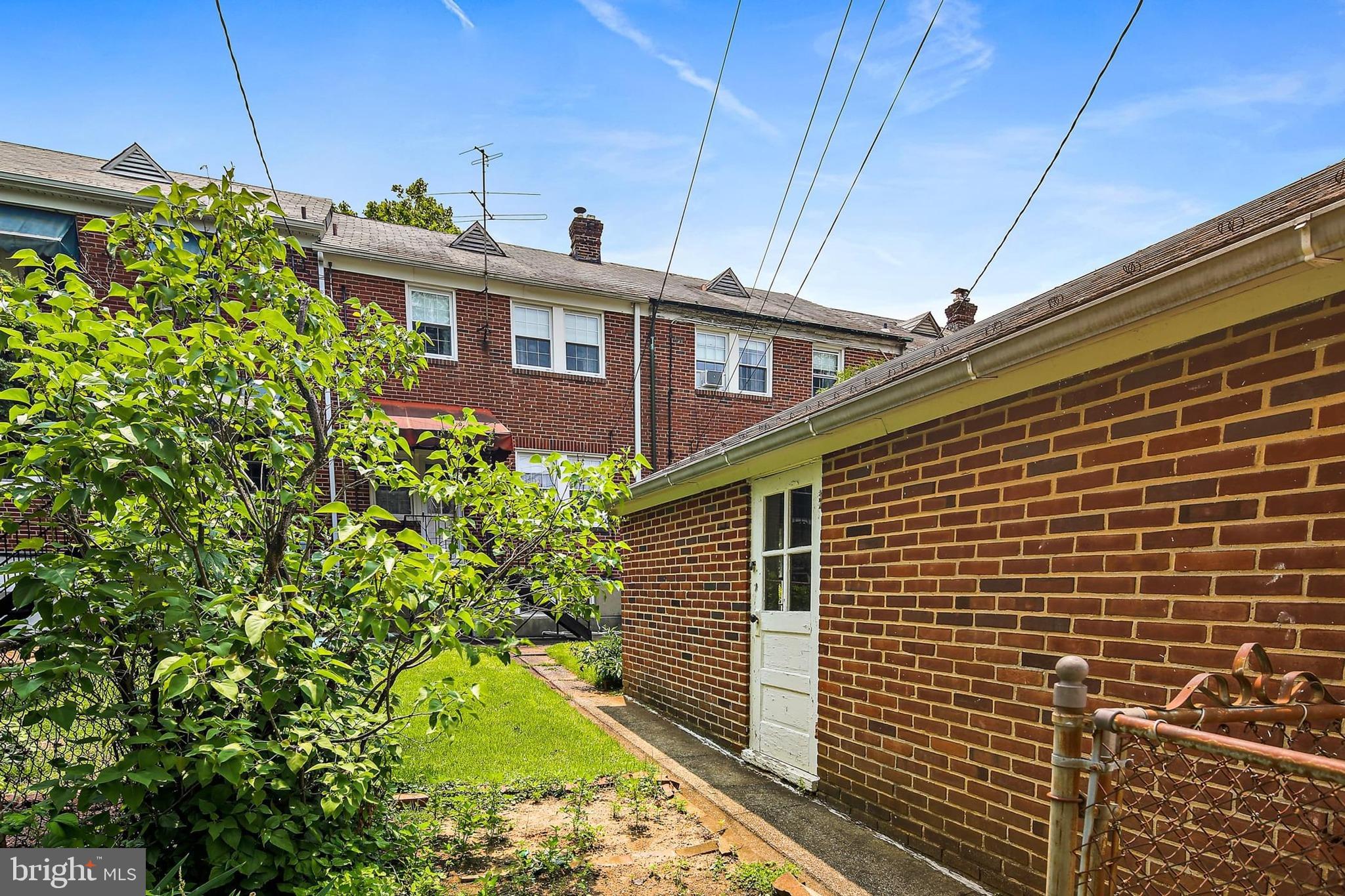 48 Dunkirk Road Baltimore, MD 21212 - Photo 29 of 34 a view of a brick house with a small yard