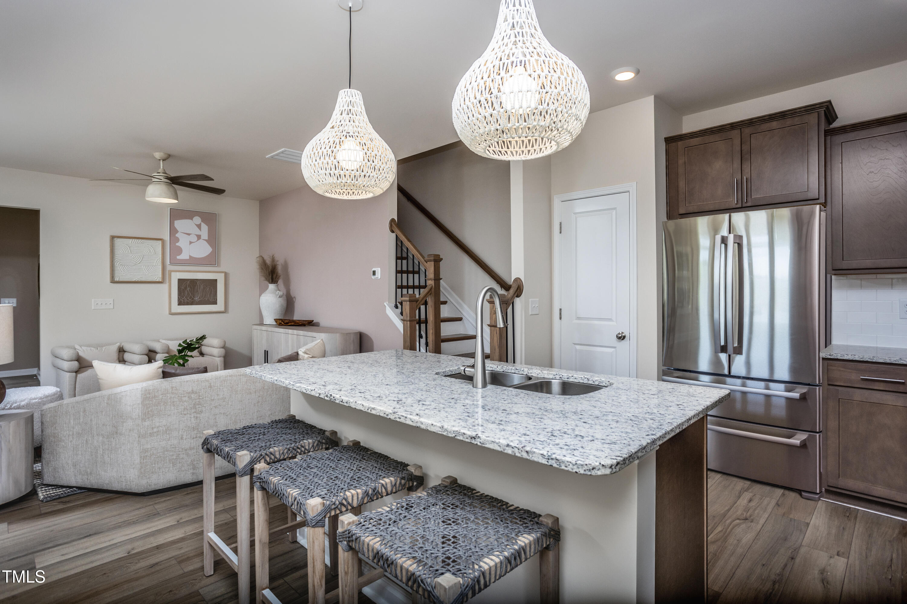 246 Broomside Avenue Raleigh, NC 27603 - Photo 5 of 24 a view of kitchen island with granite countertop living room and stainless steel appliances