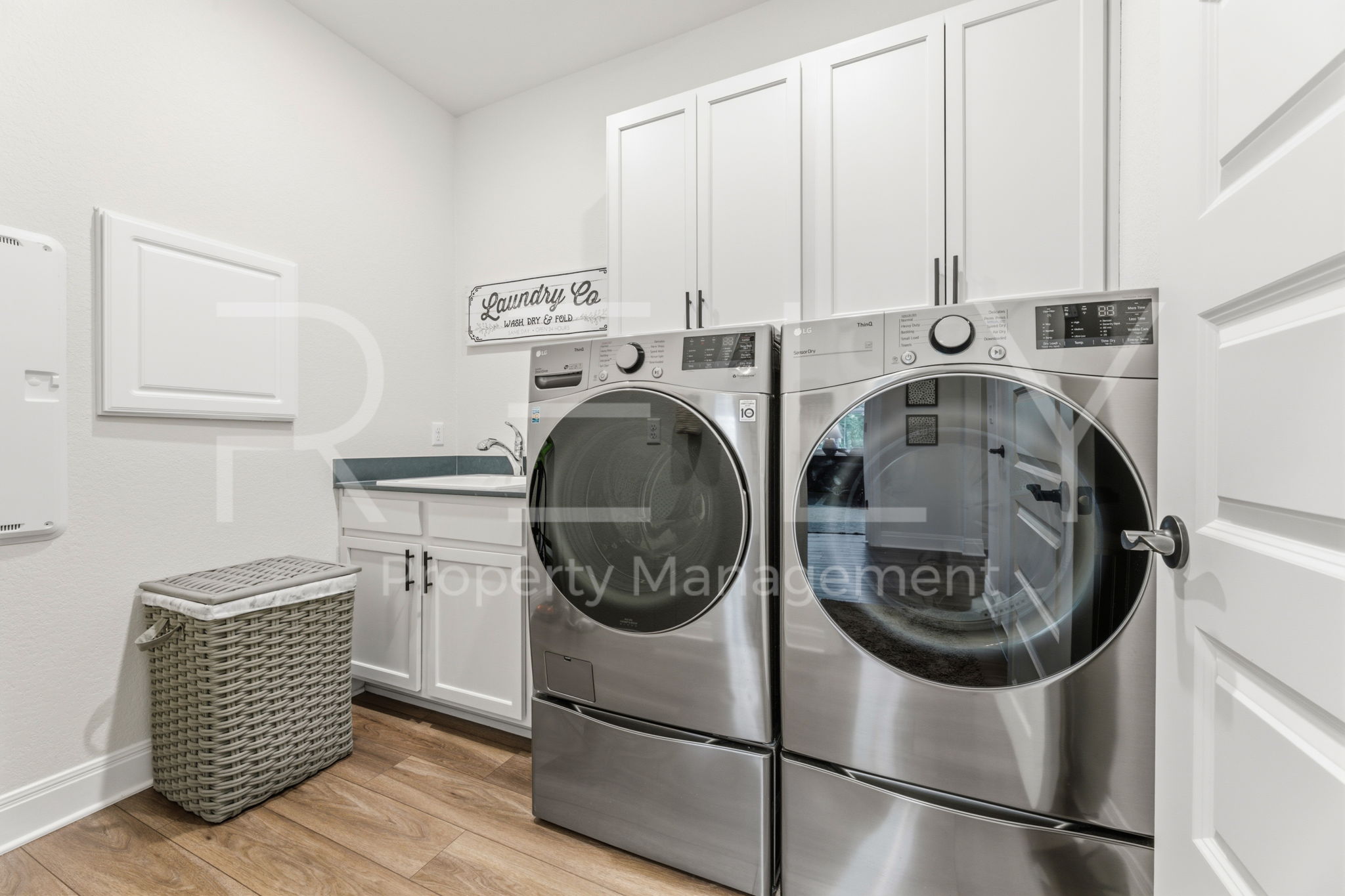 101 Spanish Star Street Georgetown, TX 78633 - Photo 32 of 39 Functional and sleek, this dedicated laundry room simplifies household chores with ample storage.