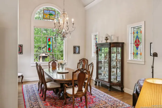 a view of a dining room with furniture a chandelier and wooden floor