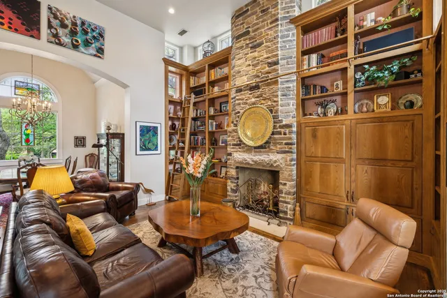 a living room with furniture a fireplace and a window