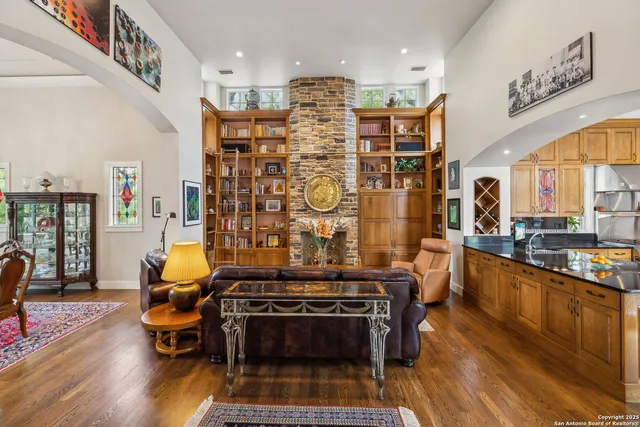 a living room with fireplace furniture and a rug