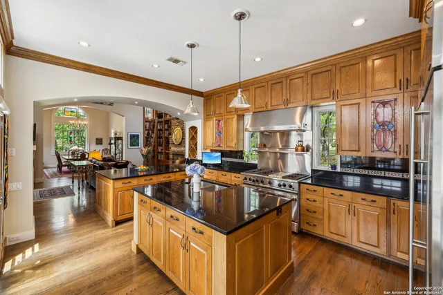 a kitchen with stainless steel appliances granite countertop a sink and a stove
