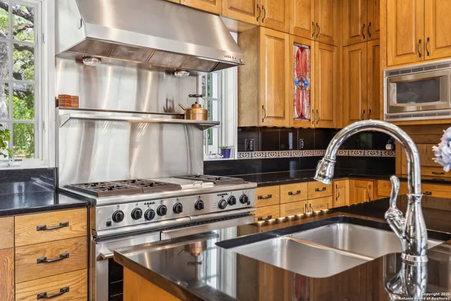 a kitchen with a stove a sink and a refrigerator
