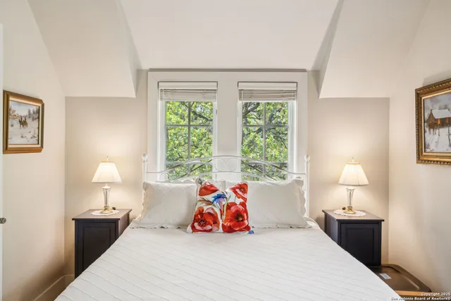 a bedroom with a bed and lamp next to a window