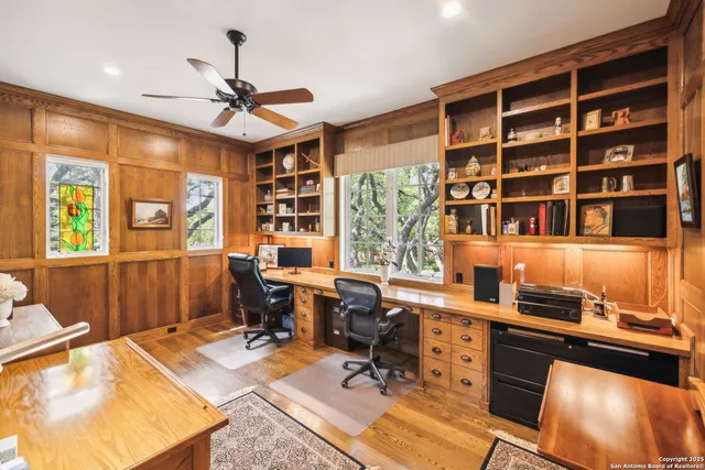 a view of a workspace with furniture and a window
