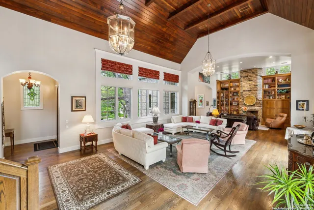 a living room with fireplace furniture and a rug