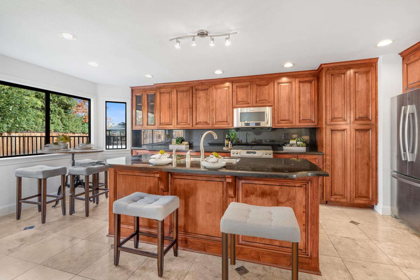 9040 Ridgeway Drive Gilroy, CA 95020 - Photo 12 of 44 a kitchen with stainless steel appliances granite countertop sink stove and refrigerator