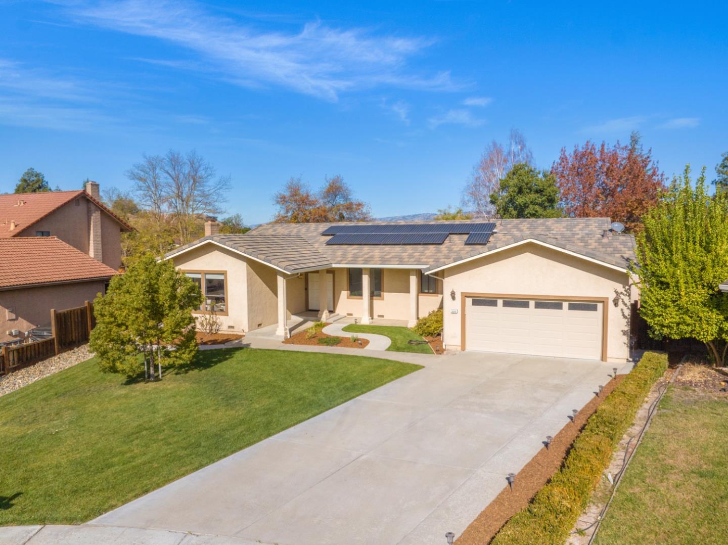 9040 Ridgeway Drive Gilroy, CA 95020 - Photo 2 of 44 a front view of a house with a yard and potted plants