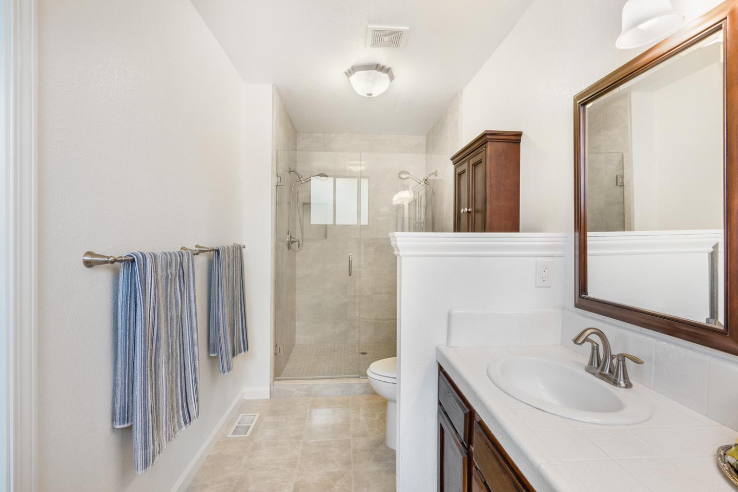 9040 Ridgeway Drive Gilroy, CA 95020 - Photo 30 of 44 a bathroom with a sink a toilet and shower