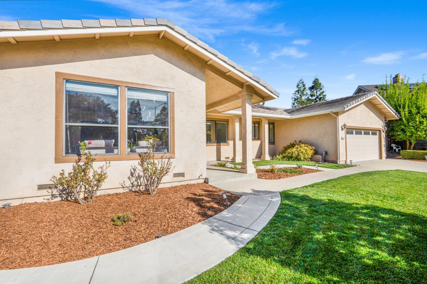 9040 Ridgeway Drive Gilroy, CA 95020 - Photo 5 of 44 a front view of a house with garden
