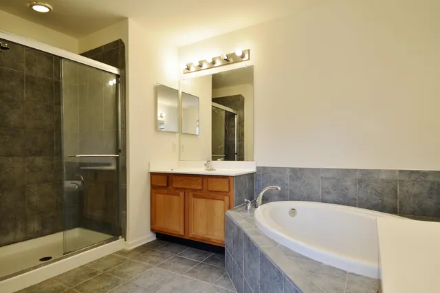 a bathroom with a bathtub sink and mirror