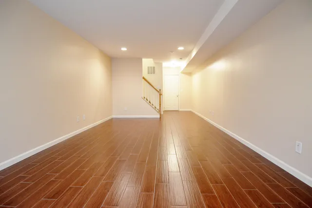 a view of room with wooden floor and window