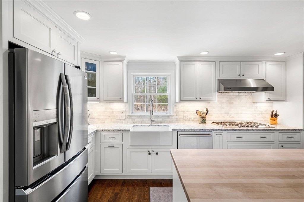 3 Wilmor Road Topsfield, MA 01983 - Photo 5 of 33 a kitchen with stainless steel appliances granite countertop a refrigerator sink and cabinets