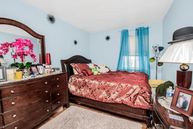 a bed sitting in a bedroom next to a window