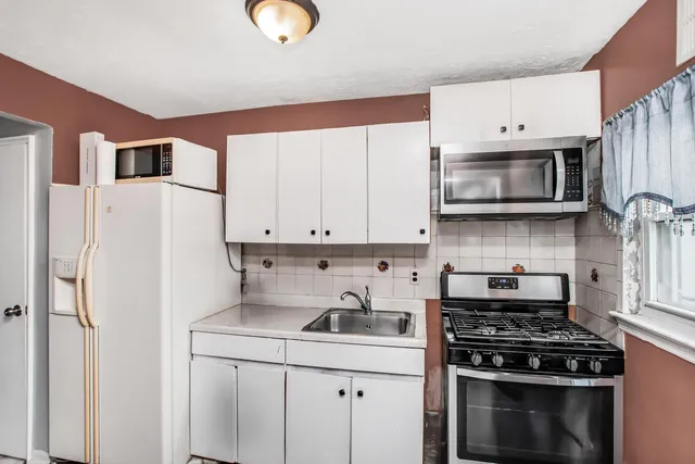 a kitchen with stainless steel appliances a stove a microwave and cabinets