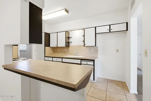 a view of a kitchen with furniture and a kitchen counter top space