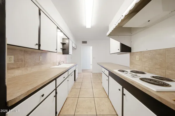 a kitchen with stainless steel appliances a sink dishwasher stove and oven with cabinets