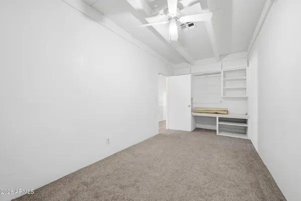 a view of a room with a ceiling fan