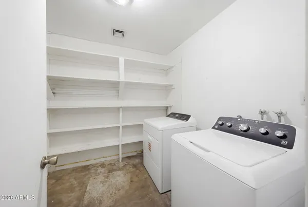 a view of storage and utility room with washer and dryer