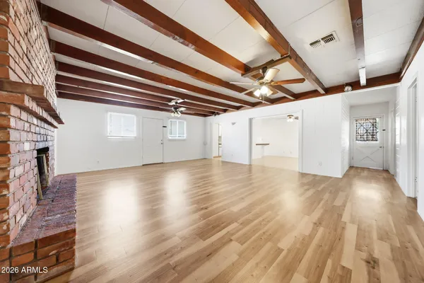 a view of empty room with wooden floor