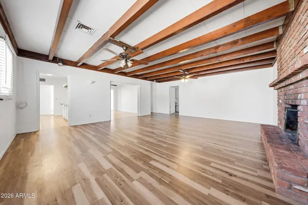 a view of empty room with wooden floor