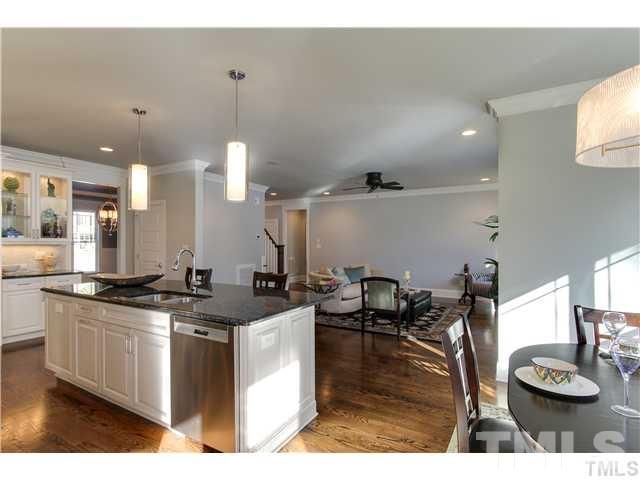 5527 Alpine Drive Raleigh, NC 27609 - Photo 15 of 15 a kitchen with stainless steel appliances granite countertop a stove a sink and a dining table