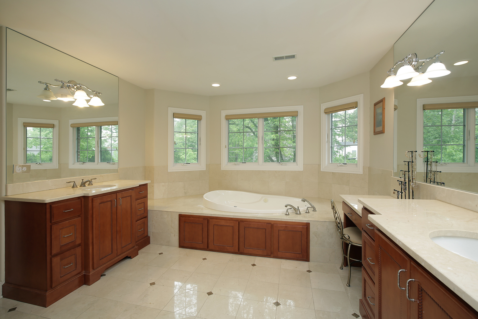 1528 Stratford Road Deerfield, IL 60015 - Photo 12 of 25 a spacious bathroom with a double vanity sink large mirror and a bathtub