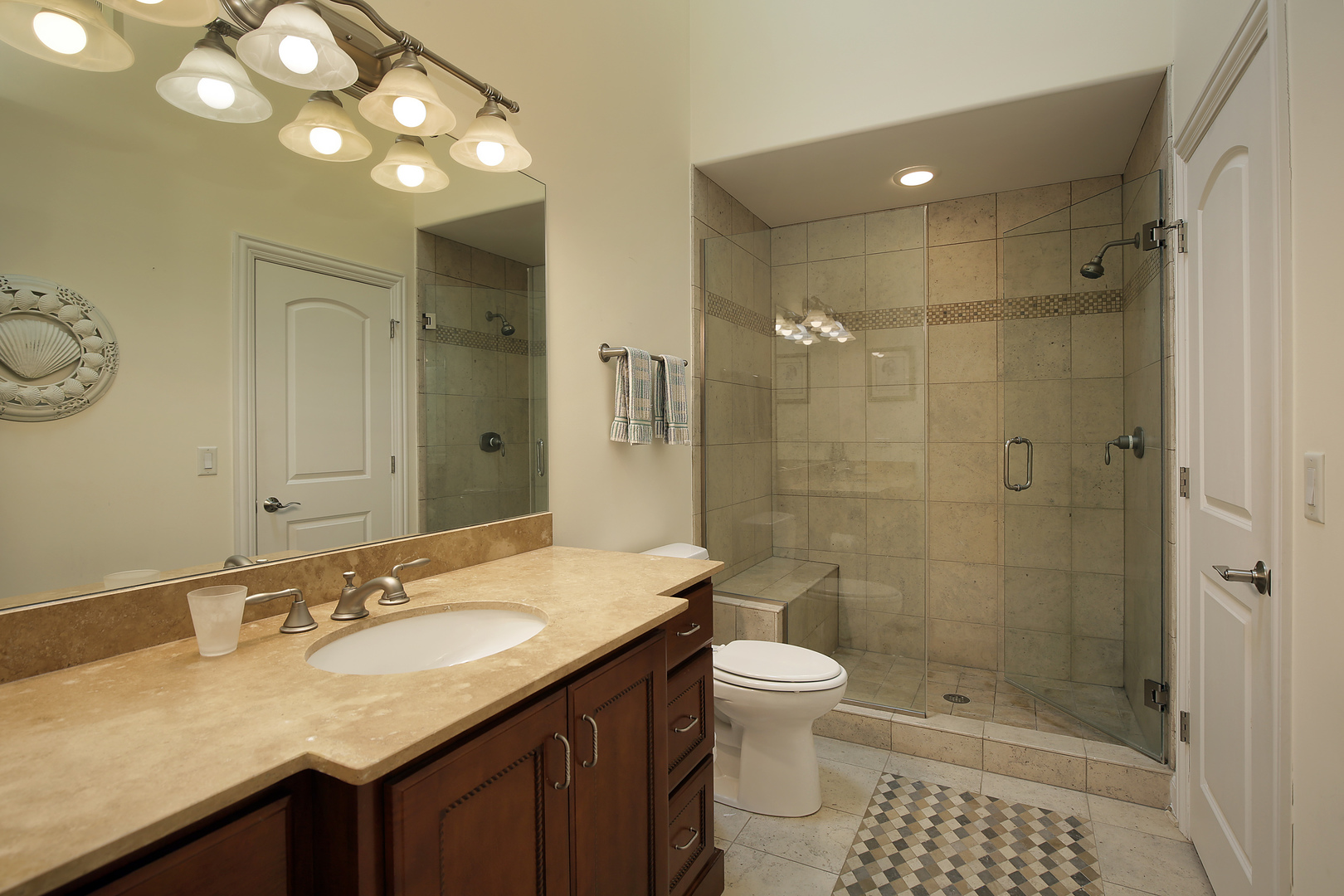 1528 Stratford Road Deerfield, IL 60015 - Photo 16 of 25 a bathroom with a granite countertop sink a toilet a mirror and shower