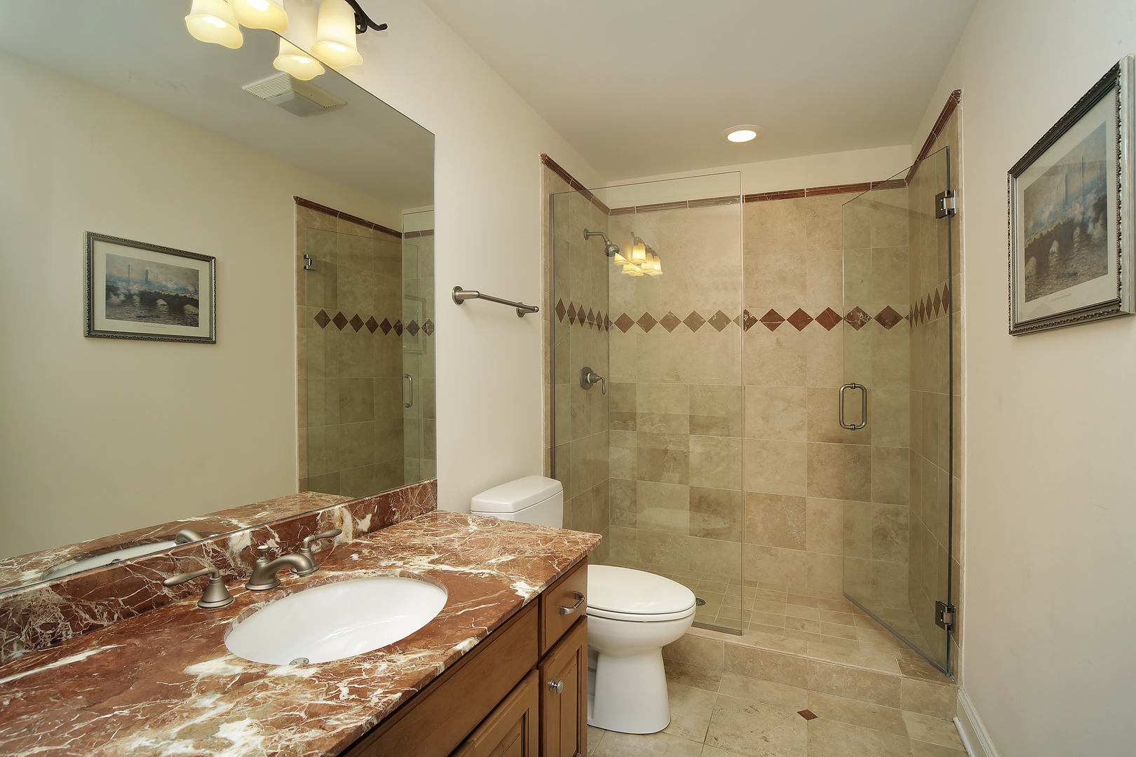1528 Stratford Road Deerfield, IL 60015 - Photo 19 of 25 a bathroom with a granite countertop sink a mirror a toilet and shower
