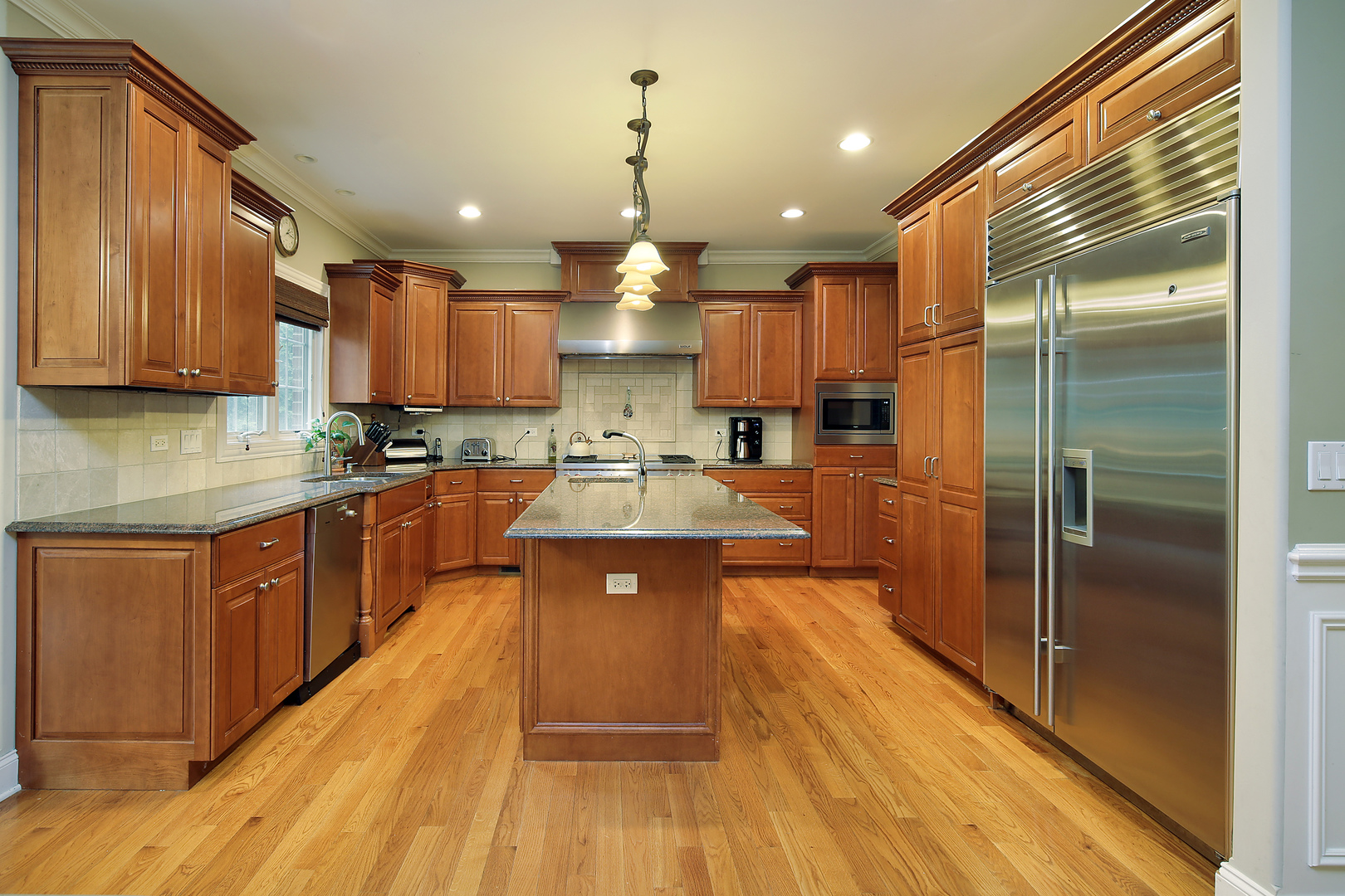 1528 Stratford Road Deerfield, IL 60015 - Photo 5 of 25 a large kitchen with stainless steel appliances granite countertop a large stove a sink dishwasher a refrigerator and wooden cabinets with wooden floor