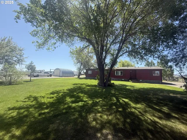a view of backyard with large trees
