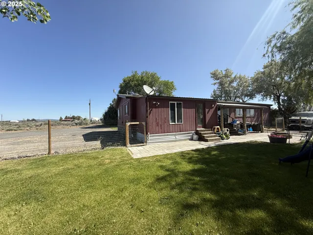 a view of a backyard with sitting area