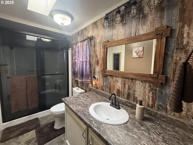 a bedroom with furniture and a flat screen tv