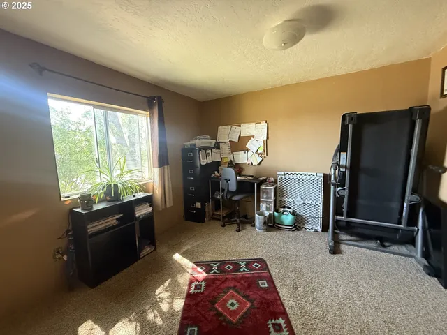 a bedroom with a bed and a mirror on the dresser