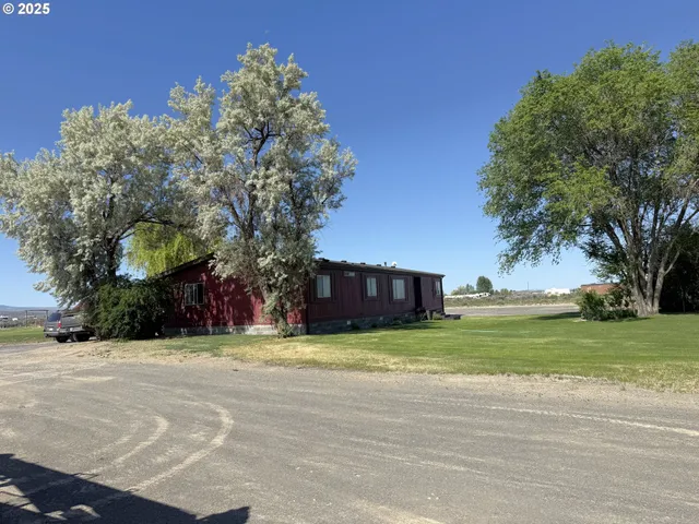 a view of a house with a yard and a garage