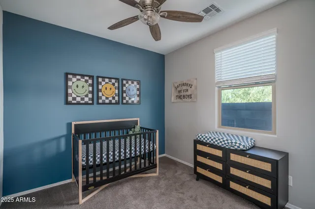 a bedroom with a bed and a computer on a desk