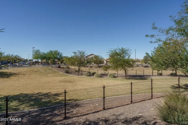 a view of a lake with a floor to ceiling window next to a yard