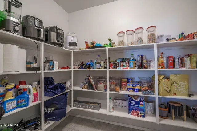 a kitchen with stainless steel appliances granite countertop a sink refrigerator and cabinets
