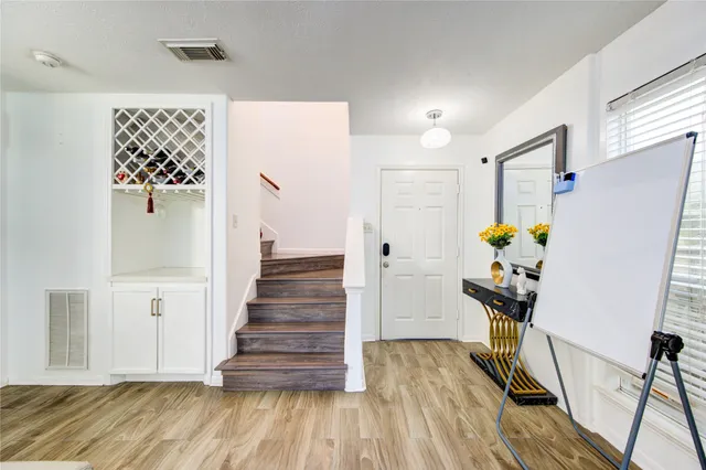 a kitchen with stainless steel appliances granite countertop a sink and a refrigerator
