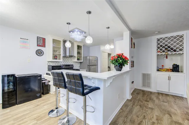 a bedroom with a bed wooden floor and window