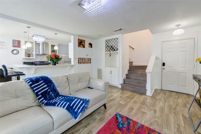 a view of a bedroom with wooden floor and stairs