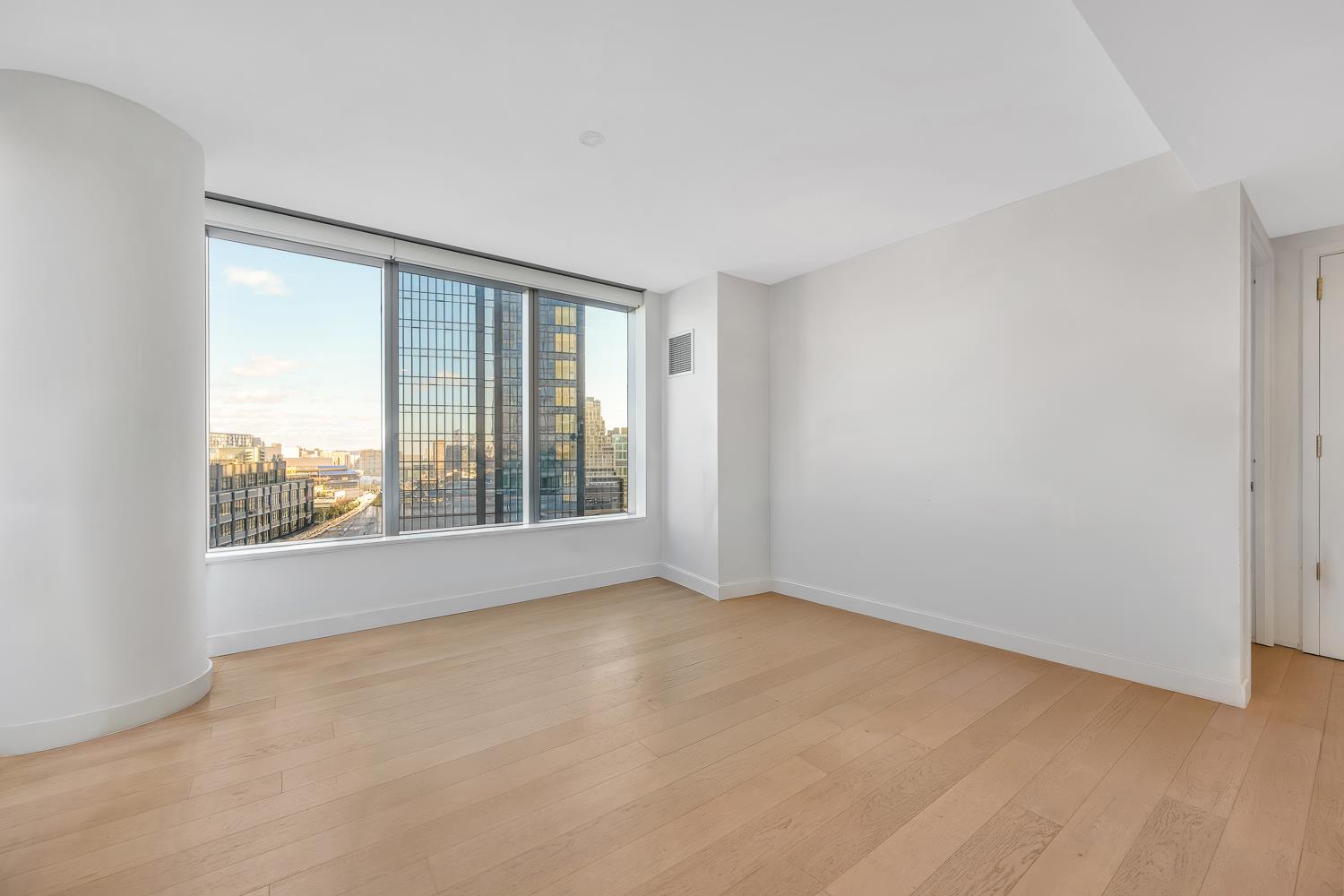 3 Court Square, Unit 902 Queens, NY 11101 - Photo 2 of 11 a view of an empty room with a window