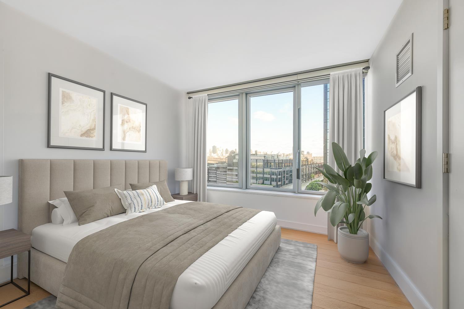 3 Court Square, Unit 902 Queens, NY 11101 - Photo 4 of 11 a bedroom with a bed and a large window