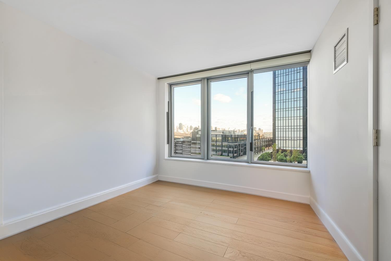 3 Court Square, Unit 902 Queens, NY 11101 - Photo 5 of 11 an empty room with windows