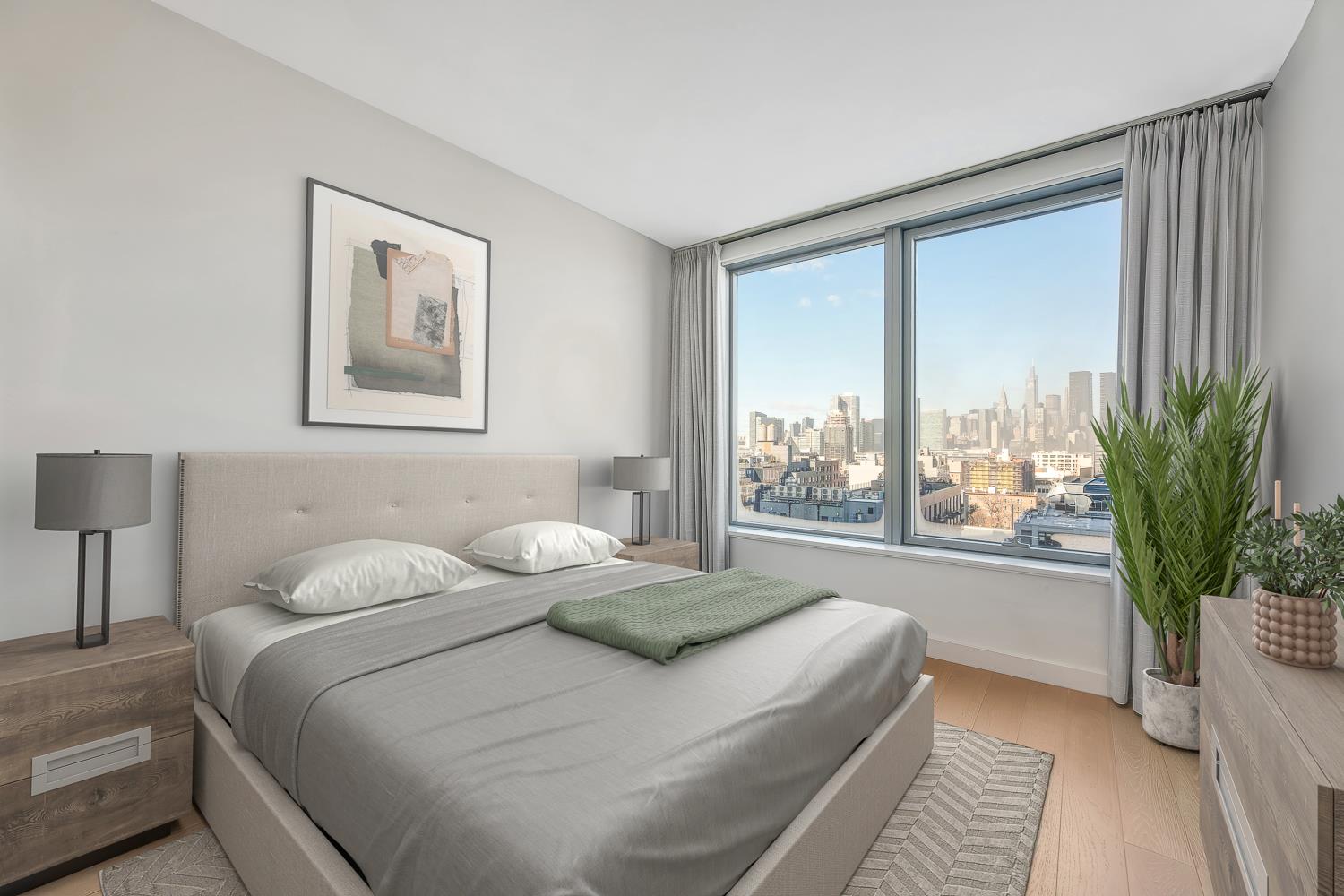 3 Court Square, Unit 902 Queens, NY 11101 - Photo 7 of 11 a bedroom with a large bed and a large window