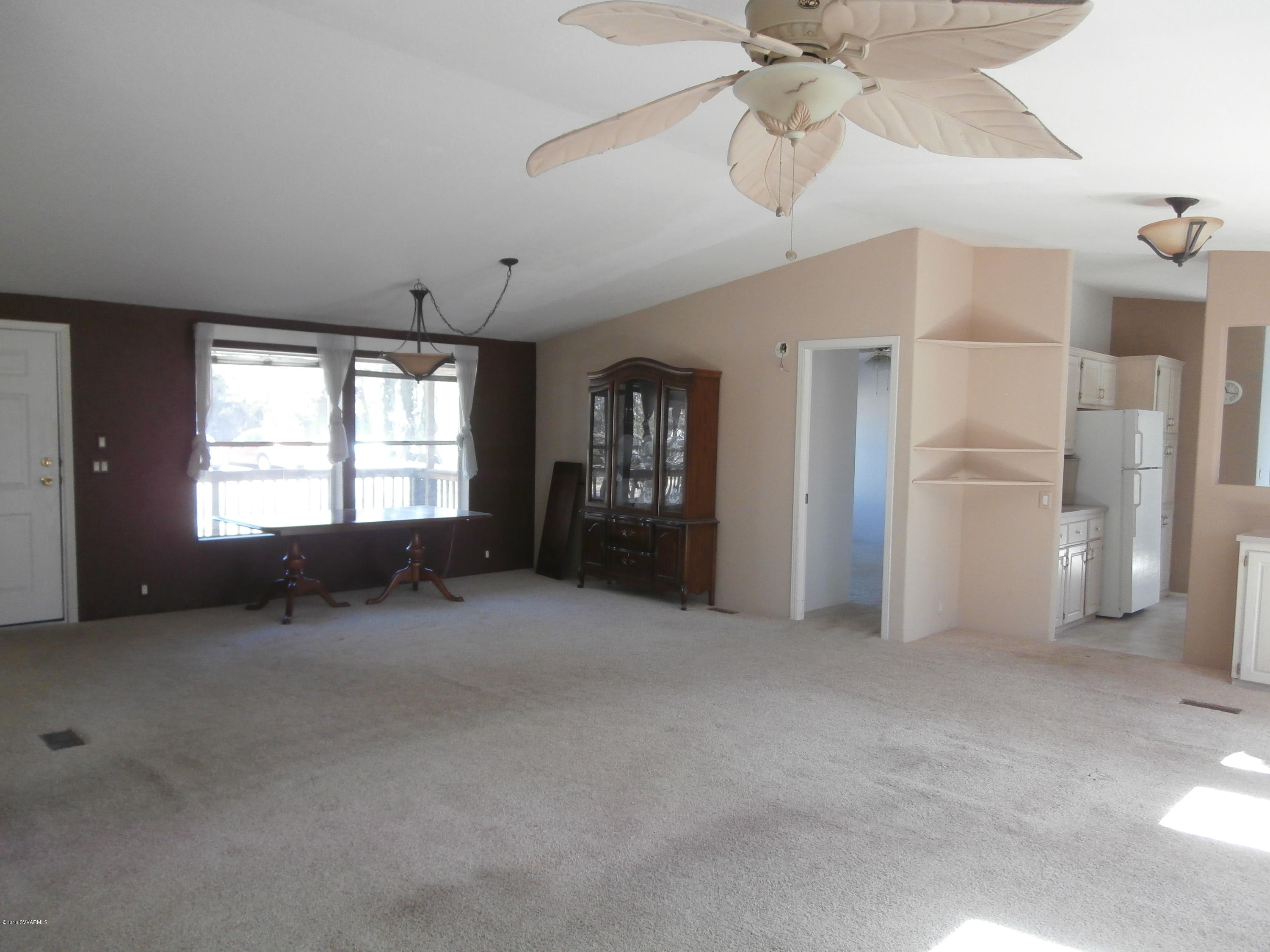 4305 East Aztec Road Rimrock, AZ 86335 - Photo 14 of 25 a view of an empty room with a window and a kitchen